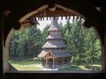 Monastery Sapanta-Peri in Maramures, Romania photographed through a sclupted window Royalty Free Stock Photo